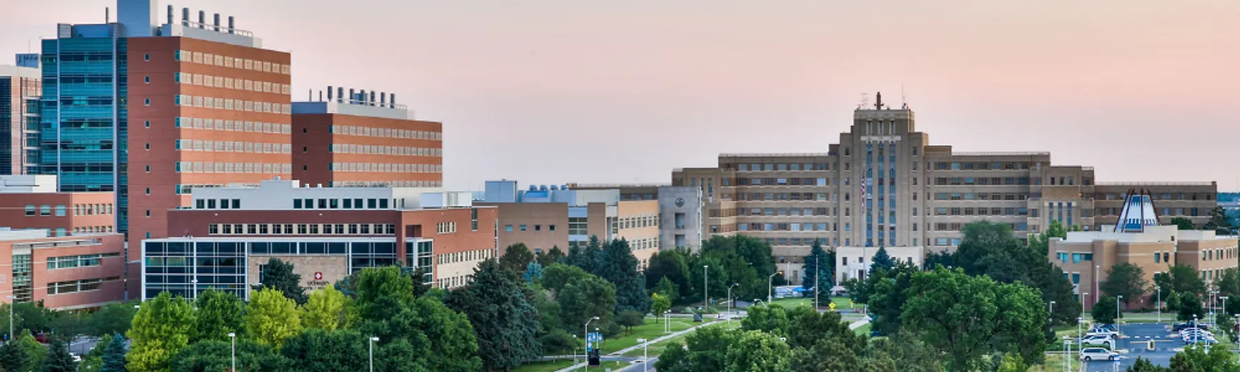 The University of Colorado Anschutz Medical Campus at dusk, research towers to the west and the historic Fitzsimons building to the east. Photo: University of Colorado Anschutz Medical Campus.